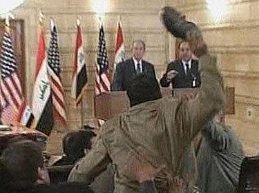 Iraqi journalist Muntader al-Zaidi throws his shoe at George Bush during a press conference