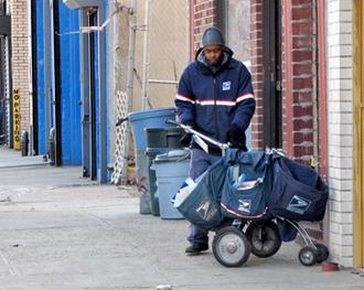 A mail carrier working a cold day in New York City