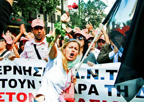 Greek workers march during a general strike last year