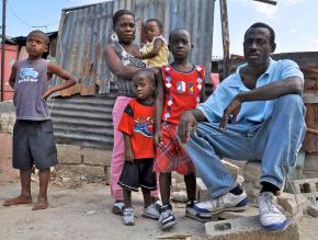 One of hundreds of thousands of homeless families still living amid the rubble in Port-au-Prince