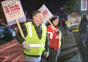 Members of Teamsters Local 117 walk the picket line at United Natural Foods Inc.