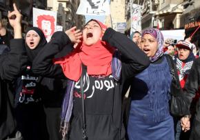 Protesters march through Cairo streets marking the second anniversary of the beginning of the revolution