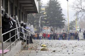 A confrontation between protesters and riot police outside a government building