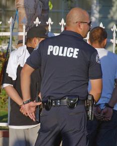 LAPD officer arresting young Latino men