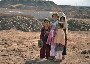 Refugee children gathered outside the war zone
